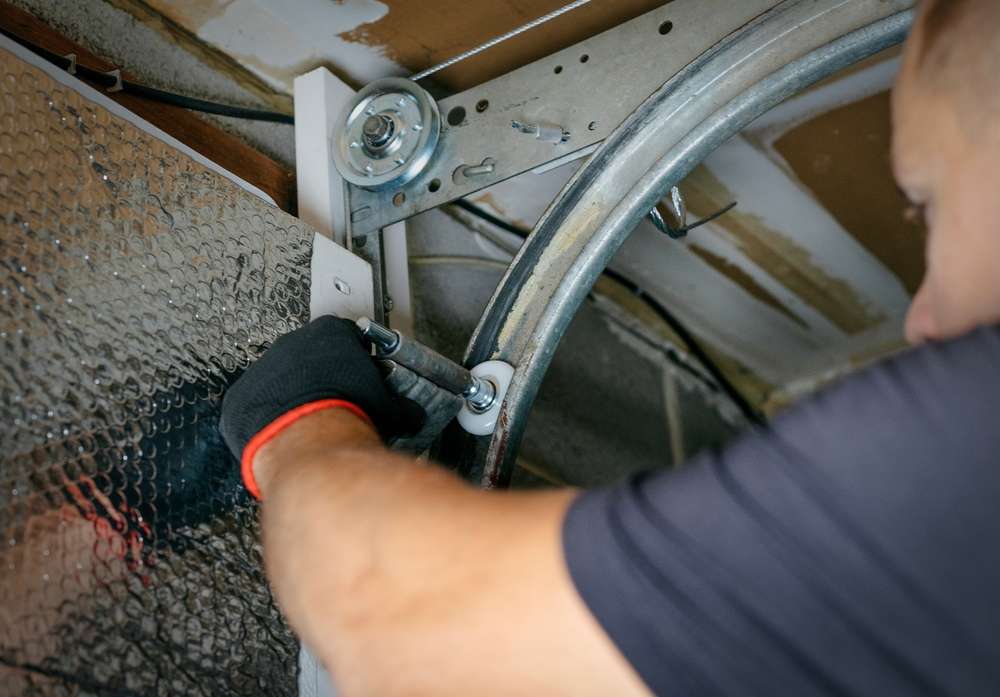 Garage Door Track Repairman fixing track Commercial Garage Door Repair technician working on garage door track