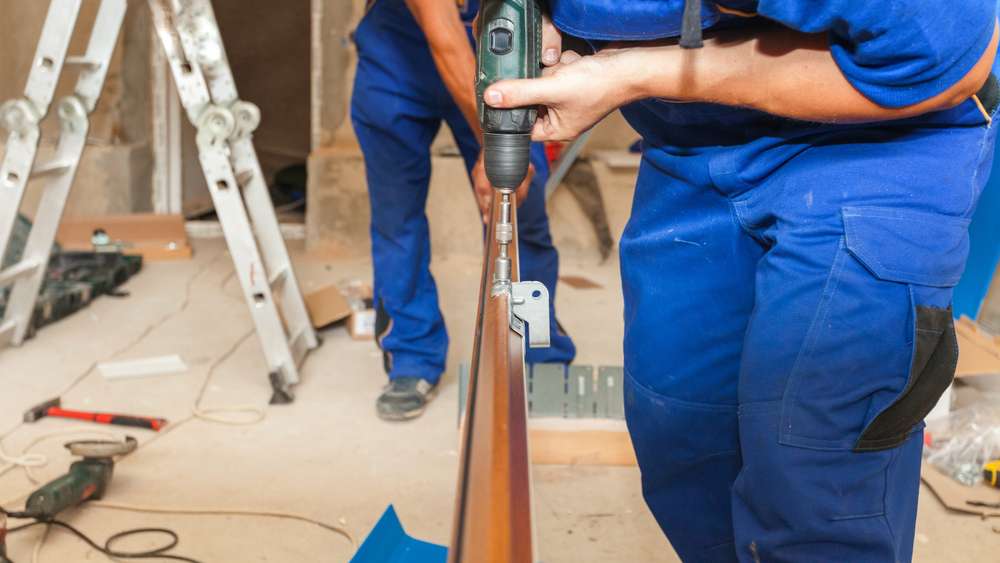 Garage Door Track Repairman fixing track Garage Door Installation technician installing garage door system in Denton