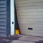 Broken,Garage,Door,For,Car,Exit,,Bent,Door,Close-up