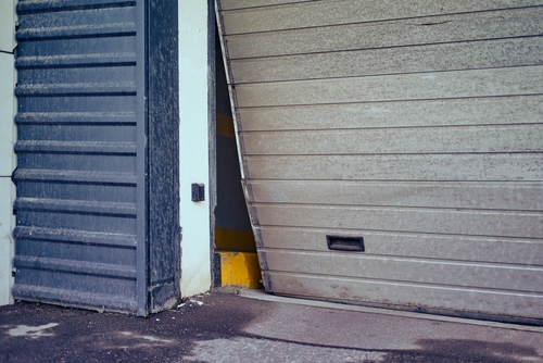 Broken,Garage,Door,For,Car,Exit,,Bent,Door,Close-up