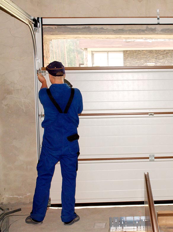 man installing garage door